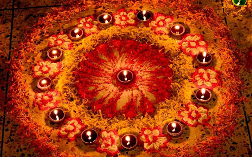 Diyas on flower rangoli