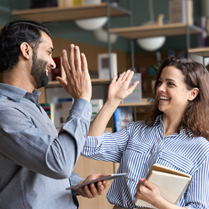 A Man and a Woman Smiling and Giving High-five to Each Other